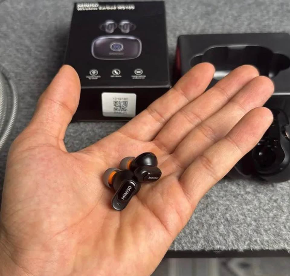 MINISO MS105 Wireless Earbuds held in hand showing compact size next to box
